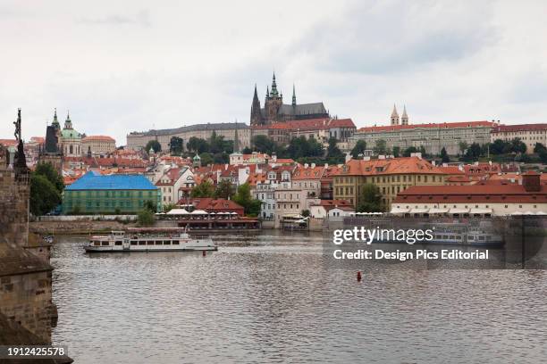 View from the Charles Bridge to the Prague Castle, Vltava River and tourist cruiseboats. Vltava River, Prague, Czech Republic.