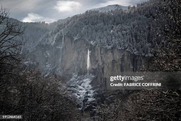 This photograph taken on January 9, 2024 shows the Staubbach Falls seen from the mountain village of Lauterbrunnen shows in the Bernese Alps.