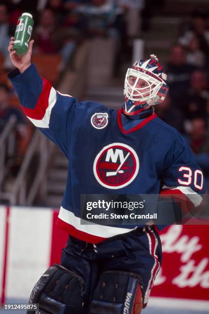 New York Islander's goalie, Mark Fitzpatrick, calls to the bench for more water during the game against the NJ Devils at the Meadowlands Arena ,East...