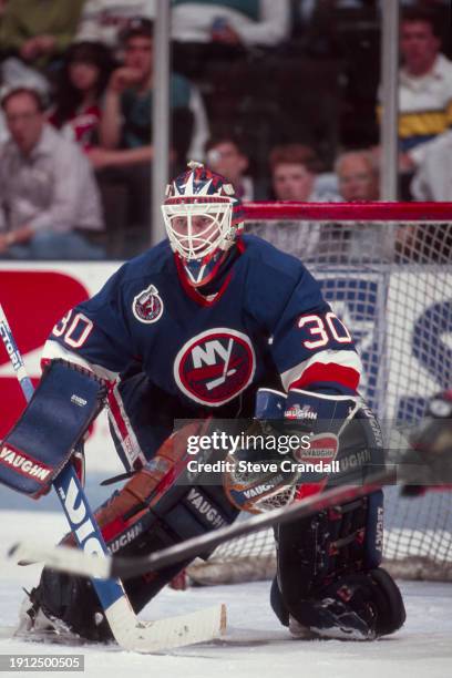 New York Islander's goalie, Mark Fitzpatrick, is focused on the puck as the Devil's try to score during the game against the NJ Devils at the...