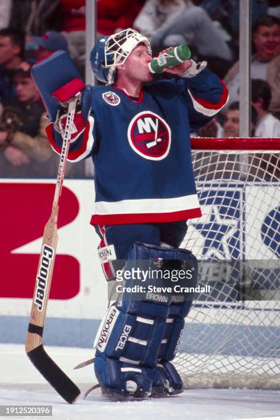 New York Islander's goalie, Glenn Healy, takes a water break during a time out during the game against the NJ Devils at the Meadowlands Arena ,East...