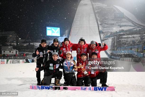 First Place, Ryoyu Kobayashi of Japan celebrates with his trophy and members of his team after victory in the FIS World Cup Ski Jumping Four Hills...