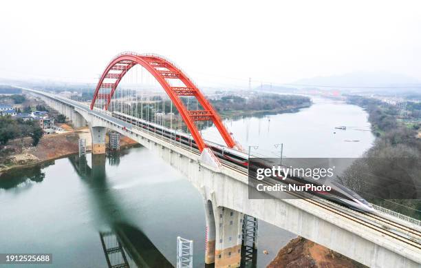 The G4015 high-speed train is running on the Hangzhou-Nanchang High-Speed Railway Changjiang Super Bridge in Nanchang, China, on January 9, 2024.