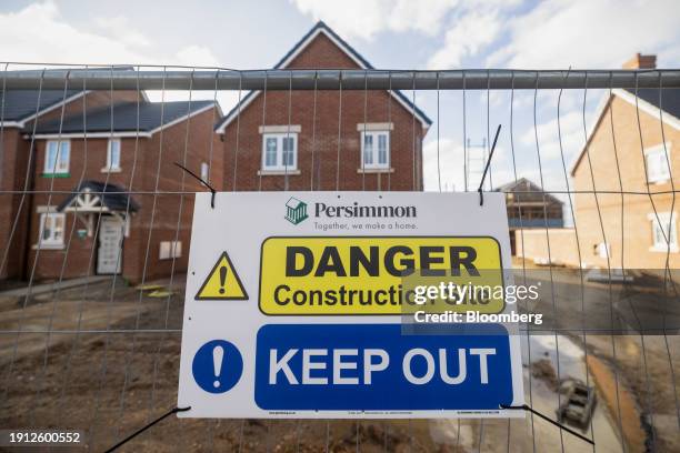 Danger sign on perimeter fencing at a Persimmon Plc residential property construction site in Colchester, UK, on Tuesday, Jan. 9, 2024. Easing...