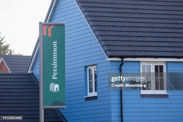 Flag outside the show home at a Persimmon Plc residential property construction site in Colchester, UK, on Tuesday, Jan. 9, 2024. Easing mortgage...