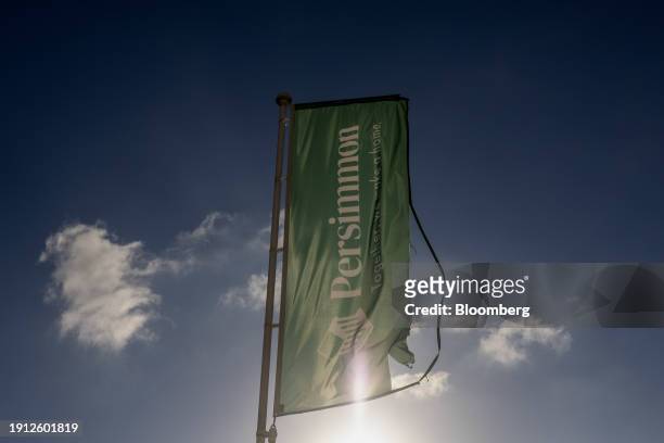 Flag bearing the company logo at a Persimmon Plc residential property construction site in Colchester, UK, on Tuesday, Jan. 9, 2024. Easing mortgage...