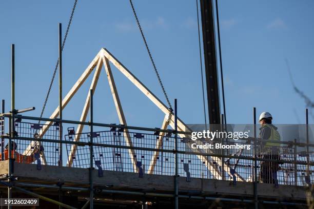 Roofing joist section is lowered in to position at a Persimmon Plc residential property construction site in Braintree, UK, on Tuesday, Jan. 9, 2024....