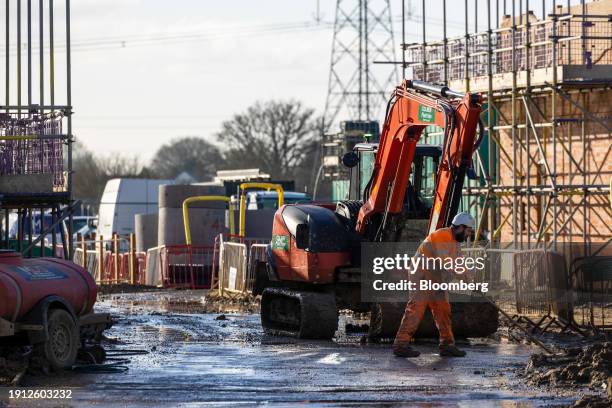 An employee clears debris from the entrance to a Persimmon Plc residential property construction site in Braintree, UK, on Tuesday, Jan. 9, 2024....