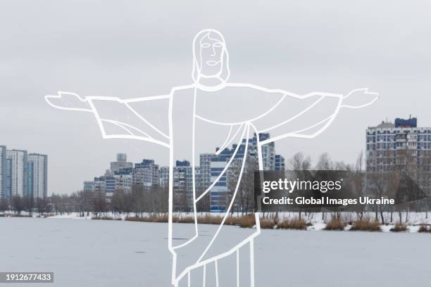 Metal installation of Jesus Christ with Kyiv residential buildings on the background during Epiphany celebrations on January 6, 2024 in Kyiv,...