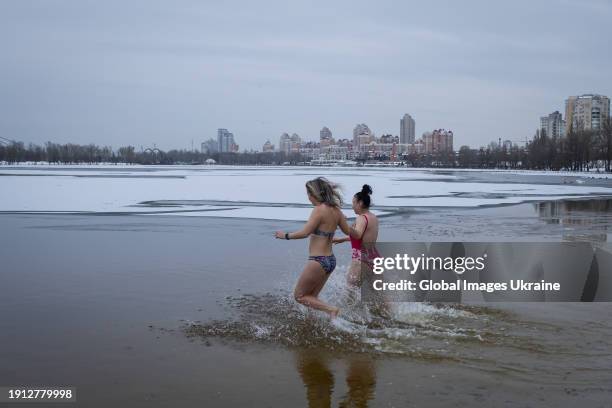 Women plunge into cold water of Dnipro river during Epiphany celebrations on January 6, 2024 in Kyiv, Ukraine. Ukraine celebrates Epiphany on 6...