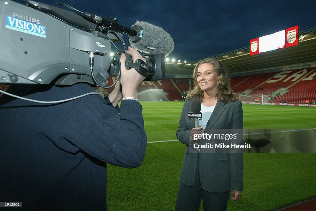 Sky television presenter Claire Tomlinson standing pitch-side