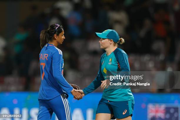 Harmanpreet Kaur of India and Alyssa Healy of Australia shake hands after the Women's T20I match between India and Australia at DY Patil Stadium on...