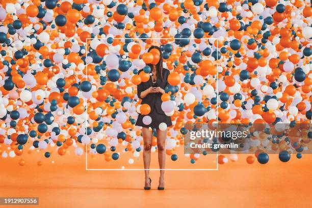 abstract woman txt messaging surrounded with large group of balloons - surrounding imagens e fotografias de stock