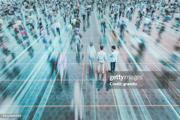 businessmen on the street standing in crowds of walking people - we're on the move stock pictures, royalty-free photos & images