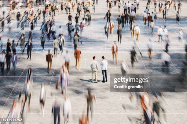 businessmen on the street standing in crowds of walking people - agir photos et images de collection