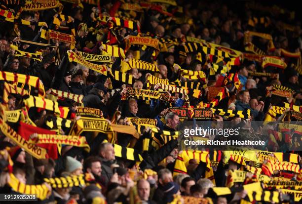 Watford fans raise their scarfs during the Emirates FA Cup Third Round match between Watford and Chesterfield at Vicarage Road on January 06, 2024 in...