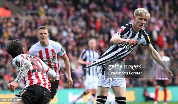 Newcastle player Anthony Gordon has his shirt ripped by Sunderland player Trai Hume during the Emirates FA Cup Third Round match between Sunderland...