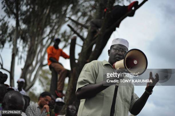 Malik Obama, a step brother to America's Democratic presidential hopeful Barak Obama, talks with the aid of a bulhorn November 2, 2008 to villagers...