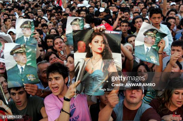 Lebanese youths carry pictures of Lebanon's new president Michel Sleiman and national pop star Haifa Wehbe during celebrations organized by the 11...