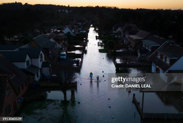 An aerial view shows floodwater surrounding homes and houses on a residential street in Wraysbury, west of London on January 9 after heavy rain...