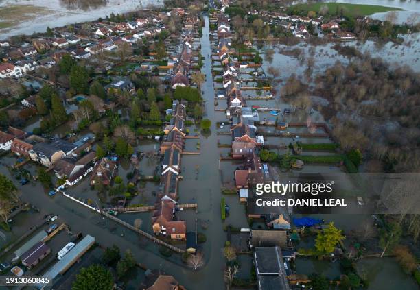 An aerial view shows floodwater surrounding homes and houses on a residential street in Wraysbury, west of London on January 9 after heavy rain...