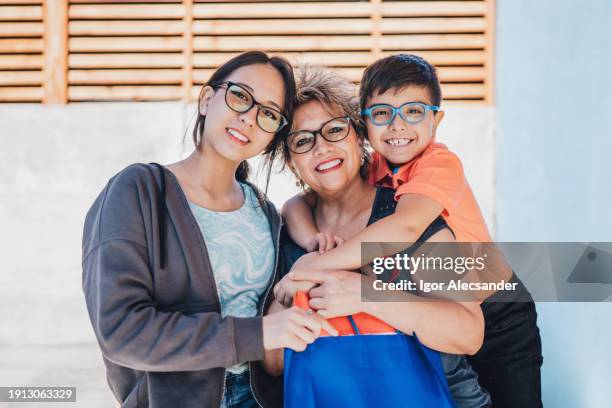 couple of children hugging their mother in the backyard - chilean people stock pictures, royalty-free photos & images