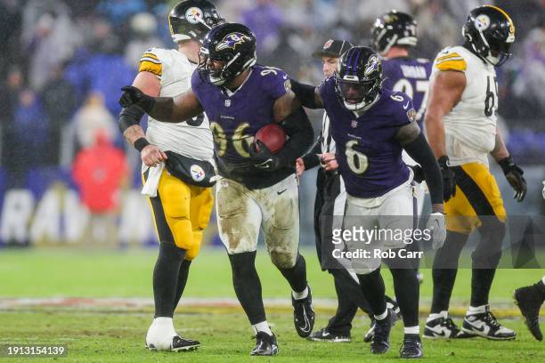 Broderick Washington of the Baltimore Ravens celebrates with Patrick Queen after recovering a fumble in the second quarter of a game against the...