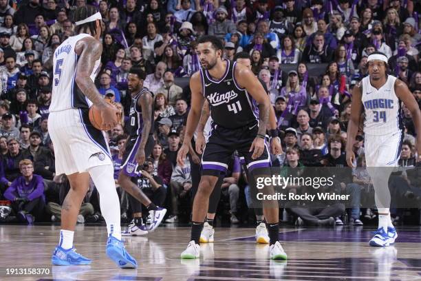 Trey Lyles of the Sacramento Kings defends against Paolo Banchero of the Orlando Magic during the game on January 3, 2024 at Golden 1 Center in...