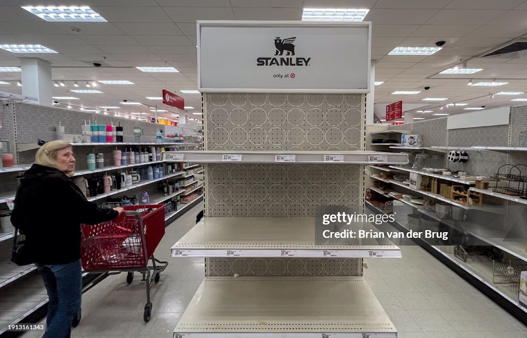 A shopper looks over empty shelves once stocked with Stanley insulated steel tumblers...