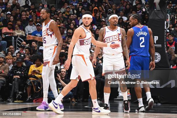 Kevin Durant, Devin Booker, and Bradley Beal of the Phoenix Suns look on during the game against the LA Clippers on January 8, 2024 at Crypto.Com...