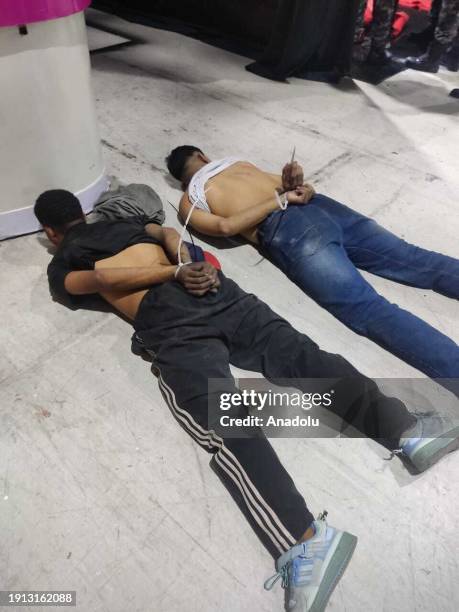 General view of suspects handcuffed with plastic handcuffs by the Ecuador forces as Ecuador president declares 'internal armed conflict,' orders...