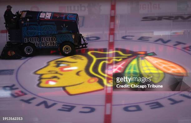 The ice is smoothened as the Chicago Blackhawks logo is illuminated before a game against the Nashville Predators at United Center on April 23 in...