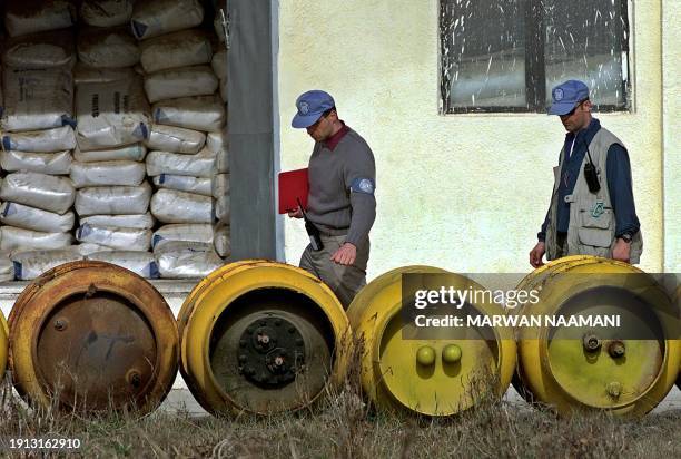 Monitoring, Verification and Inspection Commission experts check tanks of chlorine at a water purification factory in Mahmoudiya, 40 kms south of...