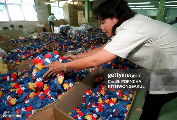 Worker at the Eddu Plush factory in Bangkok prepares for shipping dolls of World Cup '98 mascot "Footix" 09 June. Some two million of the toys have...