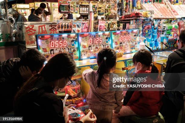 This photo taken on January 9, 2024 shows children playing at the Shanhua night market in Tainan.