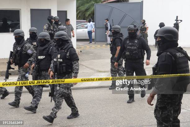 Police and soldiers take security measures as Ecuadorian police arrest several armed men who broke into the set of a public television channel after...