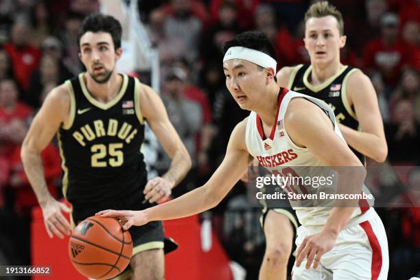 Keisei Tominaga of the Nebraska Cornhuskers drives up the court ahead of Ethan Morton of the Purdue Boilermakers in the first half at Pinnacle Bank...