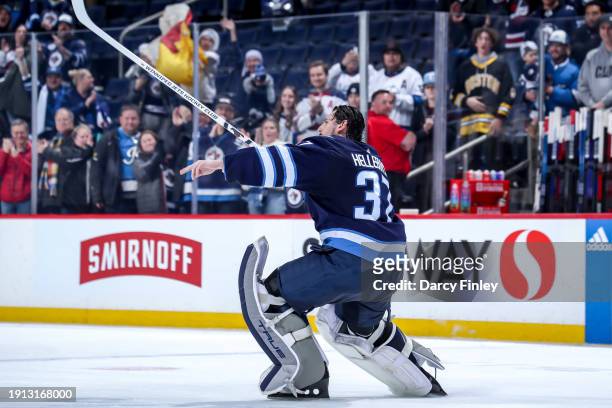 Goaltender Connor Hellebuyck of the Winnipeg Jets celebrates after receiving first star honours following a 5-0 shutout victory over the Columbus...