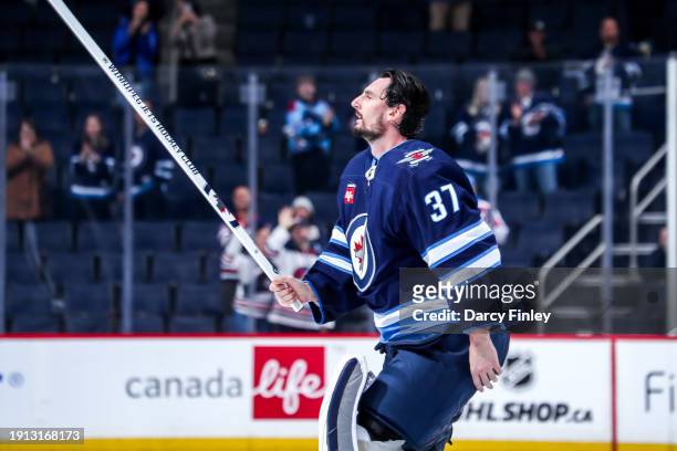 Goaltender Connor Hellebuyck of the Winnipeg Jets salutes the fans after receiving first star honours following a 5-0 shutout victory over the...