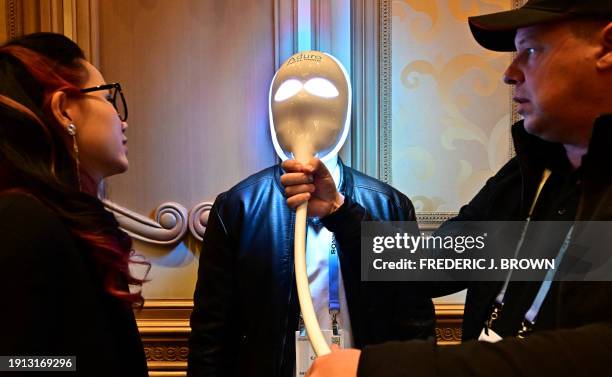 Man tries on the Aduro Facial Tronic facemask from Red Lite Therapy Collective during Showstoppers on January 9, 2024 at the Consumer Electronics...