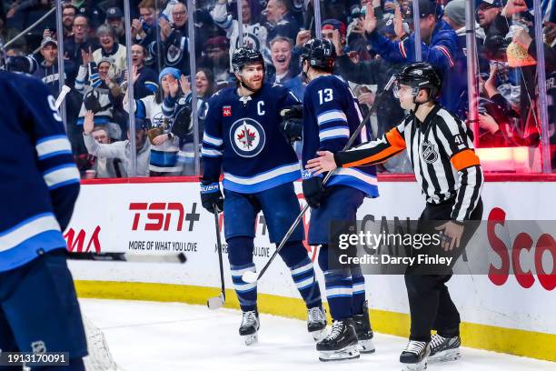 Adam Lowry and Gabriel Vilardi of the Winnipeg Jets celebrate a third period goal against the Columbus Blue Jackets at the Canada Life Centre on...