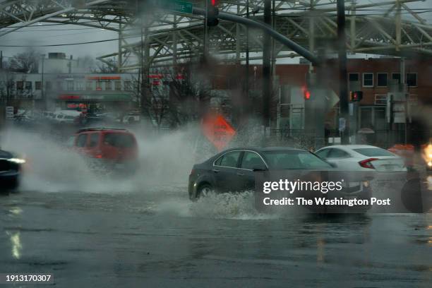 Langley Park, Maryland Cars make their way through flooding at the intersection of University Blvd. And New Hampshire Ave. In Langley Park, MD. On...