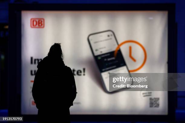 Commuter waiting near an advertisement for Deutsche Bahn AG, on the first day of a strike by members of the Gewerkschaft Deutscher Lokomotivführer...