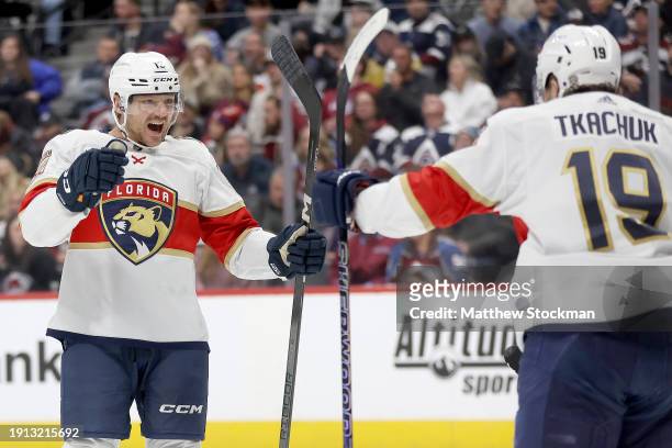 Sam Reinhart of the Florida Panthers celebrates with Matthew Tkachuk after scoring against the Colorado Avalanche in the third period at Ball Arena...