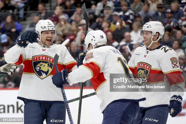 Sam Reinhart of the Florida Panthers celebrates with Matthew Tkachuk and Carter Verhaeghe after scoring against the Colorado Avalanche in the third...