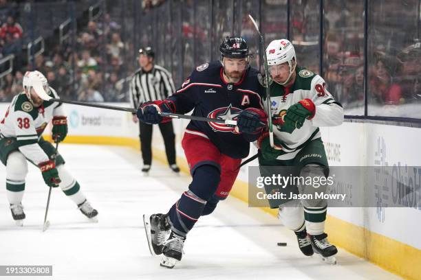 Erik Gudbranson of the Columbus Blue Jackets checks Marcus Johansson of the Minnesota Wild during the first period at Nationwide Arena on January 06,...