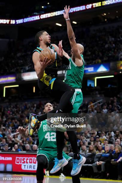 Tyrese Haliburton of the Indiana Pacers attempts a shot while being guarded by Derrick White of the Boston Celtics in the second quarter at...