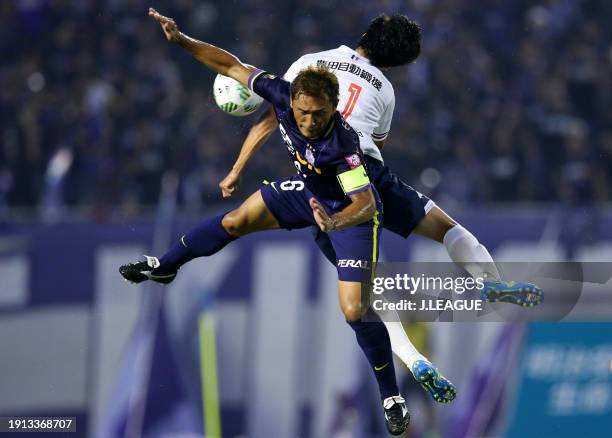 Kensuke Nagai of Nagoya Grampus and Toshihiro Aoyma of Sanfrecce Hiroshima compete for the ball during the J.League J1 second stage match between...