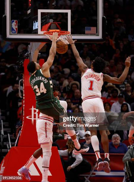 Giannis Antetokounmpo of the Milwaukee Bucks dunks the ball over Amen Thompson of the Houston Rockets in the first half at Toyota Center on January...