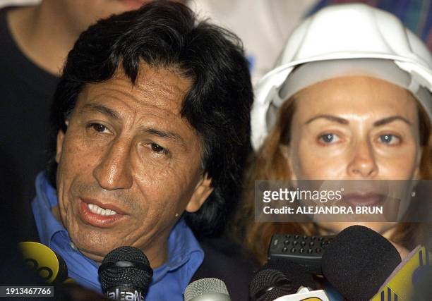 Peruvian oppositIon presidential candidate Alejandro Toledo speaks to supporters with his wife Eliane Karp on his arrival at Lima's international...